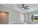 Spacious living room featuring wood-look tile flooring, high ceilings, and lots of natural light at 13972 Chesswood Ln, Port Charlotte, FL 33981