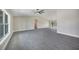 Open floor plan showcasing the living room's tile floors, high ceilings, and bright, airy atmosphere at 13972 Chesswood Ln, Port Charlotte, FL 33981