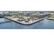 Aerial view of waterfront entertainment venue with tiki huts and colorful seating near hotels and the harbor at 150 Harborside Ave # 306, Punta Gorda, FL 33950
