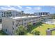 Aerial view of a multi-story condo building with a landscaped yard and well-maintained balconies at 150 Harborside Ave # 306, Punta Gorda, FL 33950
