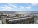 Wide aerial shot featuring waterfront condos with private parking, palm trees, a view of the bay, and a distant bridge at 150 Harborside Ave # 306, Punta Gorda, FL 33950