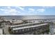 Wide aerial shot featuring waterfront condos with private parking, palm trees, a view of the bay, and a distant bridge at 150 Harborside Ave # 306, Punta Gorda, FL 33950