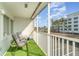 Screened balcony with artificial turf, chairs, and views of the building and nearby area at 150 Harborside Ave # 306, Punta Gorda, FL 33950