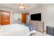 Bright bedroom featuring a large window, ceiling fan with light and light gray dresser at 150 Harborside Ave # 306, Punta Gorda, FL 33950