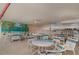 Gathering room with multiple tables and chairs, set against a backdrop of vibrant murals, create a welcoming social space at 150 Harborside Ave # 306, Punta Gorda, FL 33950