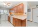 Functional kitchen featuring wood cabinets, a double sink, and a dishwasher for convenience at 150 Harborside Ave # 306, Punta Gorda, FL 33950