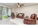 Comfortable living room showcasing leather furniture, a ceiling fan, and sliding glass doors to the outside at 150 Harborside Ave # 306, Punta Gorda, FL 33950