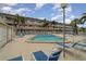A clear pool with palm trees, white fencing, and lounge chairs offers a peaceful retreat for relaxation and recreation at 150 Harborside Ave # 306, Punta Gorda, FL 33950