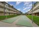Shuffleboard courts invite friendly competition, surrounded by lush greenery and charming residential buildings at 150 Harborside Ave # 306, Punta Gorda, FL 33950