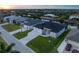 Aerial view of a waterfront community featuring beautifully landscaped homes, canal access, and private docks at 15504 Melport Cir, Port Charlotte, FL 33981