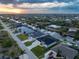 Aerial view of a waterfront community with well-maintained homes, lush landscaping, and canal access at 15504 Melport Cir, Port Charlotte, FL 33981