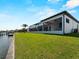 Well-maintained backyard featuring a covered patio, screened-in pool, and waterfront access with a private dock at 15504 Melport Cir, Port Charlotte, FL 33981