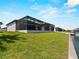 Lush backyard with a screened-in lanai, a pool, and waterfront access with a private dock at 15504 Melport Cir, Port Charlotte, FL 33981