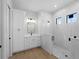 Modern bathroom featuring marble walk-in shower, vanity, and window views at 15504 Melport Cir, Port Charlotte, FL 33981