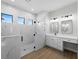 Modern bathroom with double vanity, and large walk-in shower with marble tile at 15504 Melport Cir, Port Charlotte, FL 33981