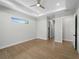 Bedroom with a ceiling fan, recessed lighting, luxury vinyl floors and a view into the hallway at 15504 Melport Cir, Port Charlotte, FL 33981
