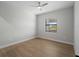 A bright bedroom with wood floors and a window at 15504 Melport Cir, Port Charlotte, FL 33981