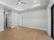 Neutral bedroom features wood look flooring, ceiling fan and doorways to the hallway at 15504 Melport Cir, Port Charlotte, FL 33981