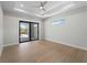 Bedroom with a slider to the lanai, recessed lights, ceiling fan and wood floors at 15504 Melport Cir, Port Charlotte, FL 33981