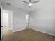 A bright bedroom with wood floors and doors leading to other rooms at 15504 Melport Cir, Port Charlotte, FL 33981