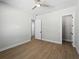 A bright bedroom with wood floors and neutral walls, featuring a ceiling fan at 15504 Melport Cir, Port Charlotte, FL 33981