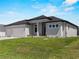 Modern home with two-car garage and large front yard at 15504 Melport Cir, Port Charlotte, FL 33981