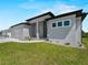 Beautiful home featuring a well-manicured lawn and an attached two car garage at 15504 Melport Cir, Port Charlotte, FL 33981