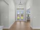 Bright foyer with wood-look floors and a chandelier at 15504 Melport Cir, Port Charlotte, FL 33981