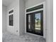 Close up of a double door entry with clerestory window at 15504 Melport Cir, Port Charlotte, FL 33981