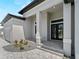 Stylish front entrance featuring a gray brick pathway and modern design at 15504 Melport Cir, Port Charlotte, FL 33981