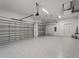 Spacious three car garage featuring epoxy floor at 15504 Melport Cir, Port Charlotte, FL 33981