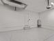 Bright, clean three car garage with painted walls and epoxy flooring at 15504 Melport Cir, Port Charlotte, FL 33981