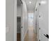 Bright hallway with wood floors leads to bathroom featuring marble shower at 15504 Melport Cir, Port Charlotte, FL 33981