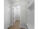 Hallway featuring white walls, trim and doors, with wood floors and a built-in bench at 15504 Melport Cir, Port Charlotte, FL 33981