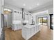 A modern kitchen with white cabinets, stainless steel appliances, and quartz countertops at 15504 Melport Cir, Port Charlotte, FL 33981