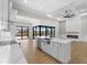 A modern kitchen with a large island, stainless steel appliances, and an open floor plan with views of the pool at 15504 Melport Cir, Port Charlotte, FL 33981
