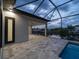 Covered lanai with a paver floor and a view of the waterfront and boat dock, with an adjacent pool at 15504 Melport Cir, Port Charlotte, FL 33981
