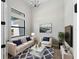 Airy living room boasts high ceilings, neutral tones, and a cozy seating arrangement with an area rug at 15504 Melport Cir, Port Charlotte, FL 33981