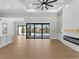 Spacious living room with a fireplace and sliding glass doors to the outdoor pool at 15504 Melport Cir, Port Charlotte, FL 33981