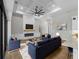 Open living room boasts a tray ceiling, fireplace, and ample seating, perfect for gatherings at 15504 Melport Cir, Port Charlotte, FL 33981