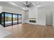 Bright living room with modern fireplace and built-ins, featuring views of the screened-in pool at 15504 Melport Cir, Port Charlotte, FL 33981