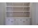 A well-organized pantry with white shelving and storage cabinets for food and household items at 15504 Melport Cir, Port Charlotte, FL 33981