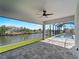 Expansive covered patio offering picturesque views of the waterfront and easy access to the screened-in pool area at 15504 Melport Cir, Port Charlotte, FL 33981