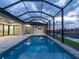 A gorgeous screened-in pool overlooks the canal for amazing views and relaxation at 15504 Melport Cir, Port Charlotte, FL 33981