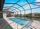 Sparkling pool in a screened enclosure with beautiful views of the canal and neighborhood at 15504 Melport Cir, Port Charlotte, FL 33981