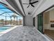 Screened pool area featuring ceiling fans, water views, and built-in fireplace at 15504 Melport Cir, Port Charlotte, FL 33981