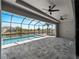 Screened in pool area with canal view and outdoor ceiling fans at 15504 Melport Cir, Port Charlotte, FL 33981