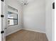 Modern room with wood floors, contemporary light fixture, and ample natural light at 15504 Melport Cir, Port Charlotte, FL 33981
