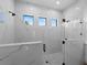 Modern bathroom shower featuring marble tile, glass door, and window at 15504 Melport Cir, Port Charlotte, FL 33981