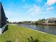 Scenic waterfront view showcasing lush green lawn, private boat docks, and serene waterways at 15504 Melport Cir, Port Charlotte, FL 33981